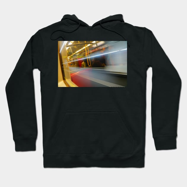 Commuters or passengers blurred in motion through window of passing train Hoodie by brians101